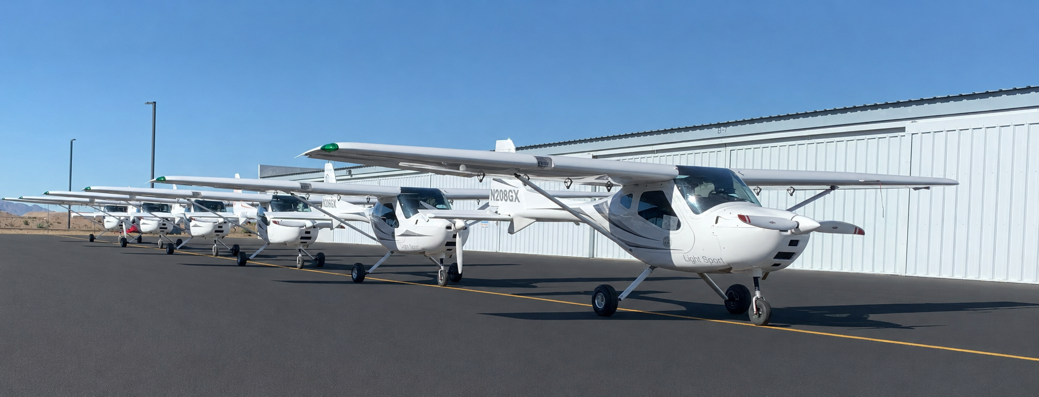 Fly Eagle Sport Remos GX fleet lineup on the ramp at KGEU Glendale Regional Airport